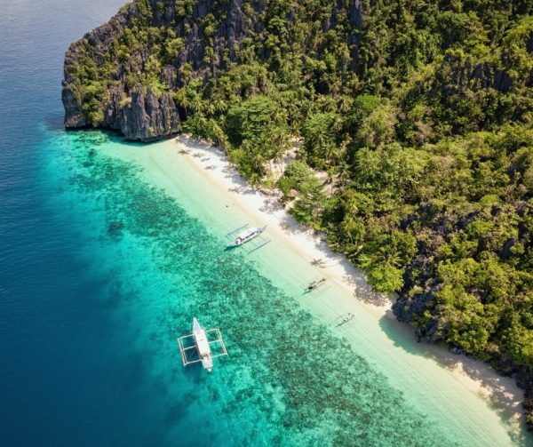 Kayaking through Twin Lagoon, Coron, Philippines, with hidden lagoon behind limestone cliffs.