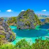Crystal-clear Kayangan Lake in Coron, Philippines surrounded by limestone cliffs.