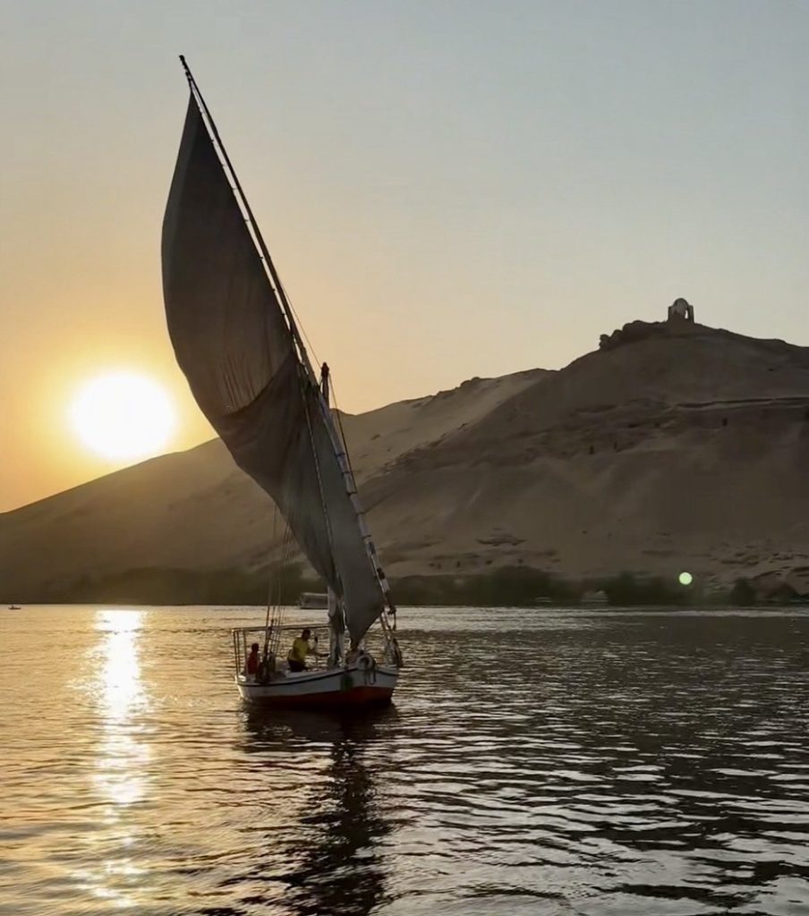 A small wooden dahabiya glides down the Nile at sunset, surrounded by palm trees and ancient temples. This intimate experience showcases a calmer, more authentic side of Egypt often missed on large cruises.