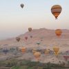 Hot air balloon at sunrise over Luxor, Egypt, with aerial views of the Nile and ancient temples