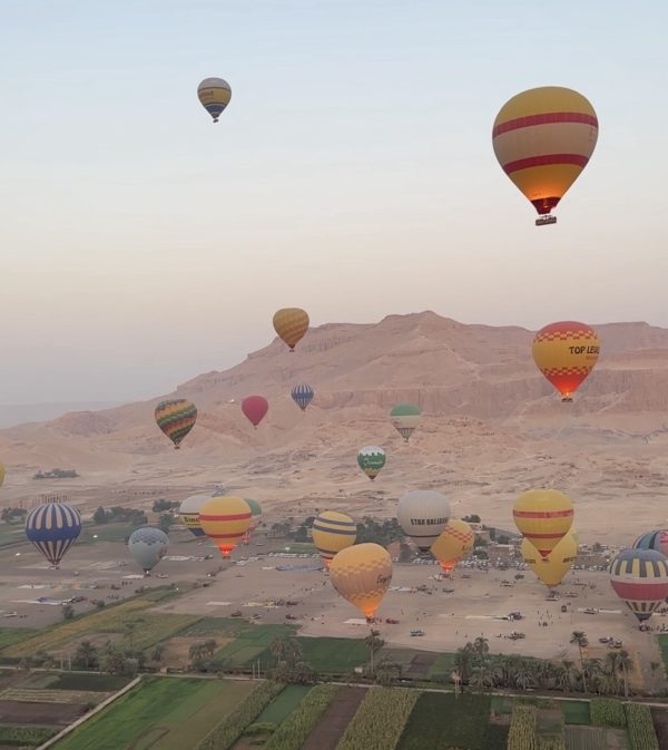 Hot air balloon at sunrise over Luxor, Egypt, with aerial views of the Nile and ancient temples