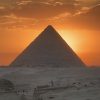 Sunset at the Pyramids of Giza in Cairo, Egypt, with golden desert light over the Great Pyramid and Sphinx