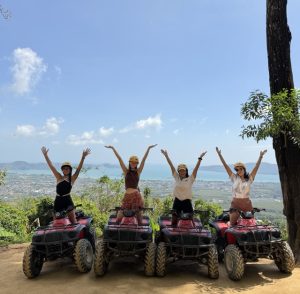 Riding an ATV through the jungle in Thailand, navigating muddy trails, forest paths, and mountain scenery