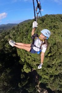 Flying through the jungle on one of the longest ziplines in Southeast Asia, surrounded by rainforest and mountain views in Thailand