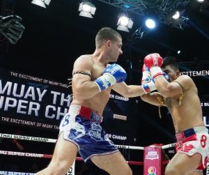 Muay Thai fight in Thailand featuring traditional rituals, powerful strikes, and an electric atmosphere inside a local boxing stadium