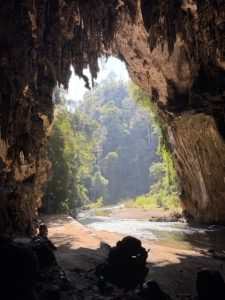 Nam Lod Cave in northern Thailand explored by bamboo raft and lantern, featuring massive limestone chambers and ancient cave formations