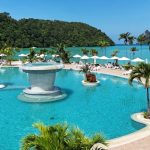 Hotel on Phi Phi Island in Thailand with beachfront views, turquoise water, and limestone cliffs in the background