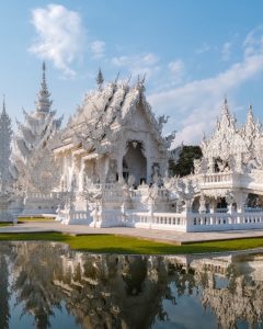 Wat Rong Khun, the White Temple in Chiang Rai, Thailand, featuring intricate white architecture and symbolic contemporary design
