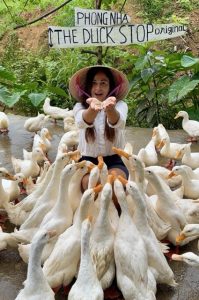 Travelers feeding ducks at Duck Stop Phong Nha Vietnam
