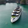 Luxury Halong Bay cruise sailing past limestone karsts in Vietnam at sunrise