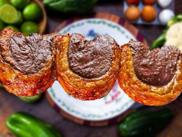 Traditional Brazilian cuisine including feijoada, picanha, pão de queijo, fresh fruit, and street food served as part of a Brazil group travel dining experience.
