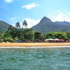 Tropical island of Ilha Grande in Brazil with jungle-covered mountains, crystal-clear water, and secluded beaches as part of a Brazil group travel itinerary.