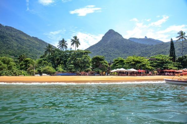 Tropical island of Ilha Grande in Brazil with jungle-covered mountains, crystal-clear water, and secluded beaches as part of a Brazil group travel itinerary.