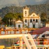 Historic colonial town of Paraty in Brazil with cobblestone streets, colorful buildings, churches, and coastal mountain backdrop as part of a Brazil group travel itinerary with Gagago.