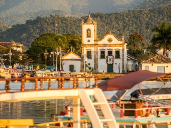 Historic colonial town of Paraty in Brazil with cobblestone streets, colorful buildings, churches, and coastal mountain backdrop as part of a Brazil group travel itinerary with Gagago.