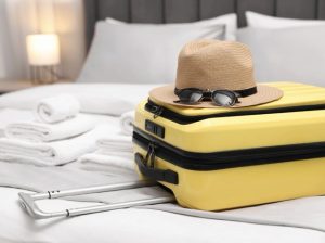 Premium travel luggage and luxury gear placed on a boutique hotel bed in a beautiful international destination