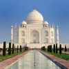 Close-up of intricate white marble floral inlay work on the Taj Mahal exterior.