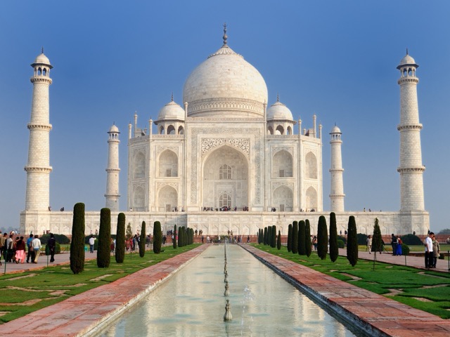 Close-up of intricate white marble floral inlay work on the Taj Mahal exterior.