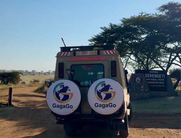 A custom Gagago 4x4 safari jeep entering the official Serengeti National Park gate to begin a luxury wildlife tour.