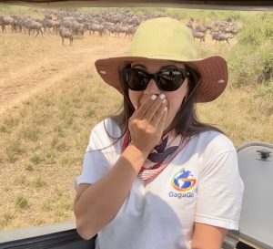 Jes travels, the founder of Gagago safaris, watching a massive herd of wildebeest gather to cross the Mara River during the Great Migration.
