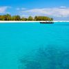Crystal-clear turquoise water and vibrant coral reef around Mnemba Island during a Gagago marine tour in Zanzibar.