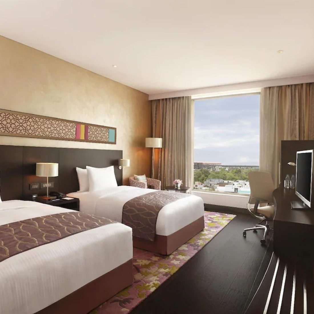 Twin room of 5-star luxury hotel in Jaipur, India, featuring premium decor.
