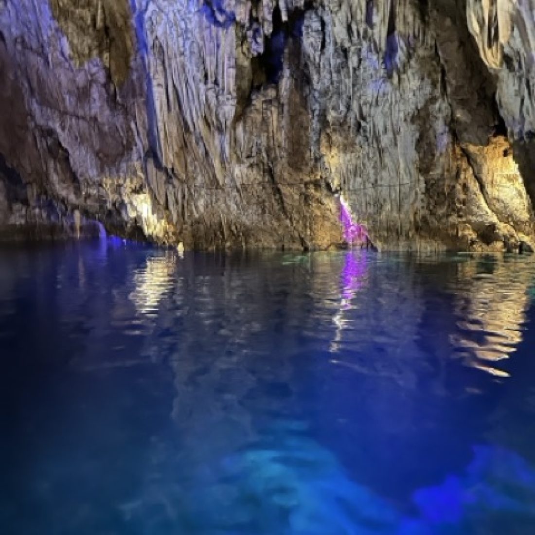 Travelers exploring a limestone cave in Coron, Philippines.