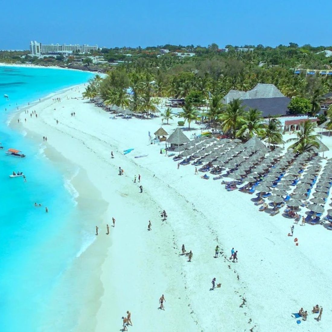 Luxury oceanfront resort overlooking swimmable turquoise waters on Kendwa Beach in Zanzibar.
