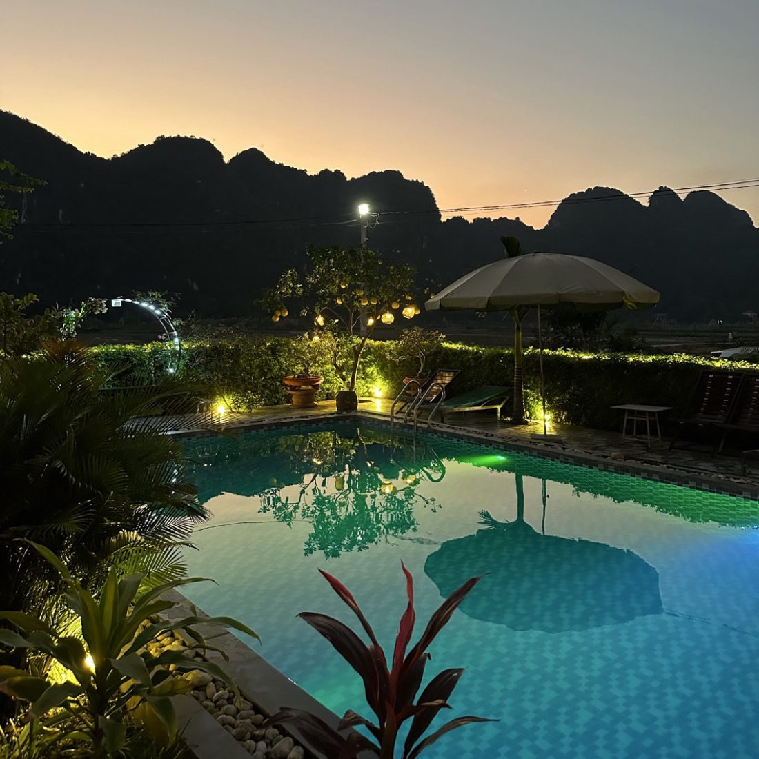 Hotel with balcony overlooking limestone karsts and rice fields in Ninh Binh, Vietnam